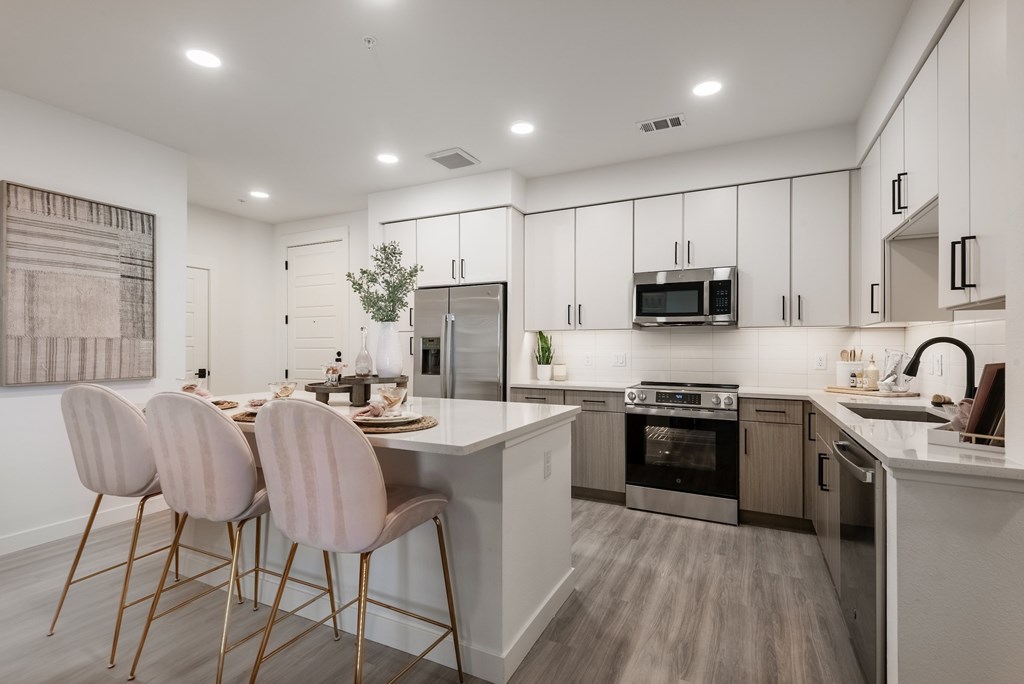 A modern kitchen with a dining table and chairs.