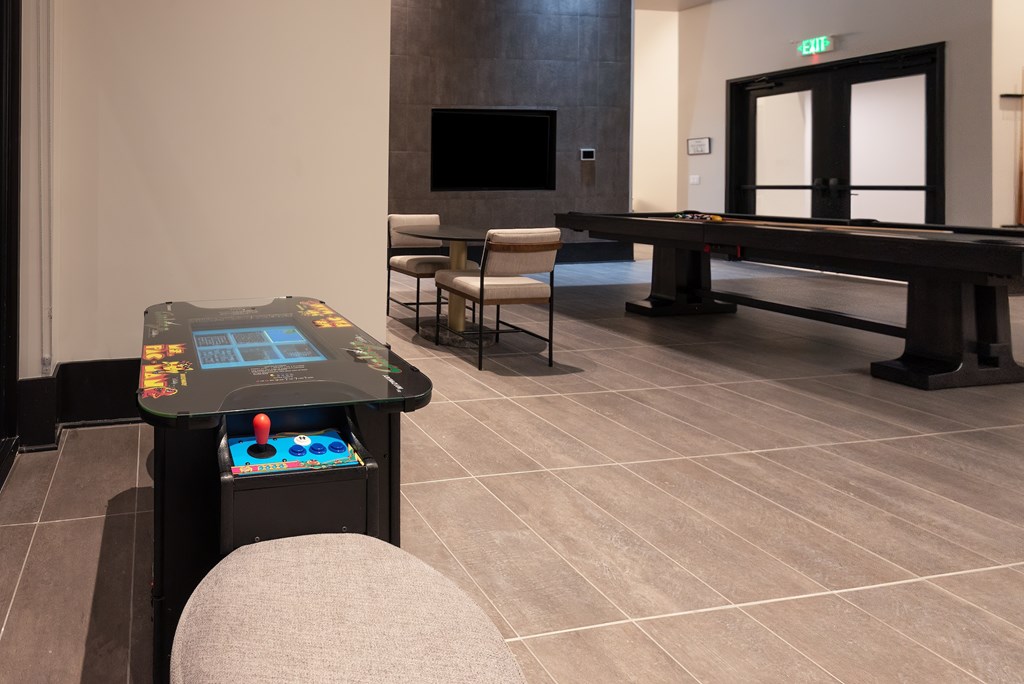 A room with a pool table and a TV.