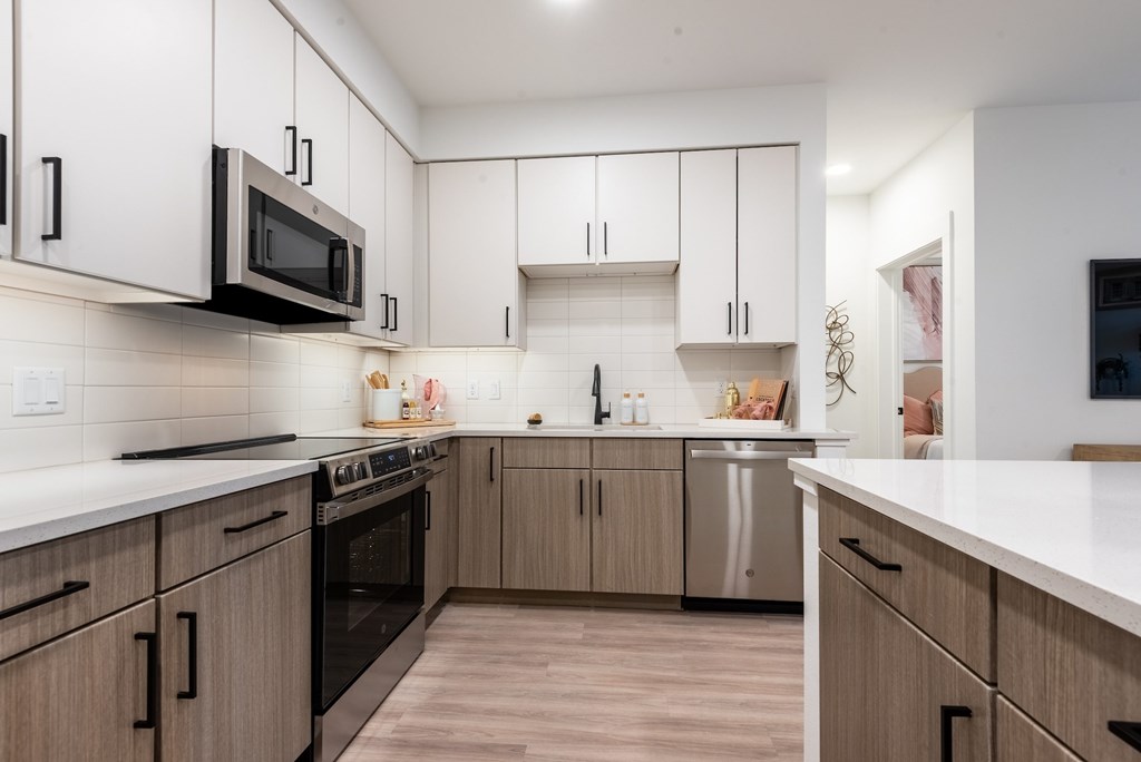 A modern kitchen with wooden cabinets and stainless steel appliances.