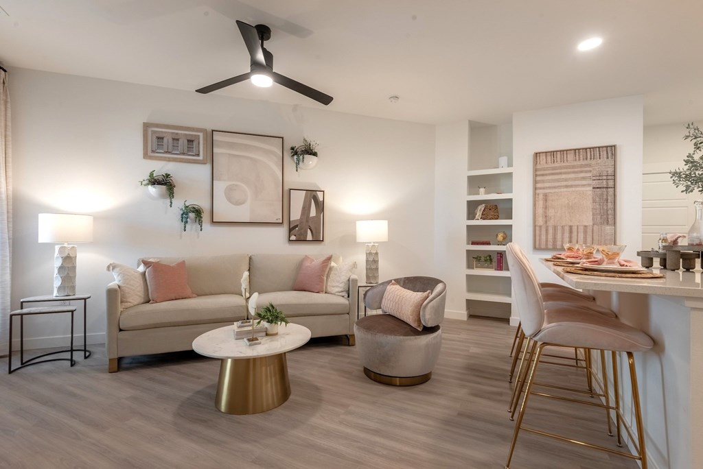 A living room with a couch, chairs, and a coffee table.