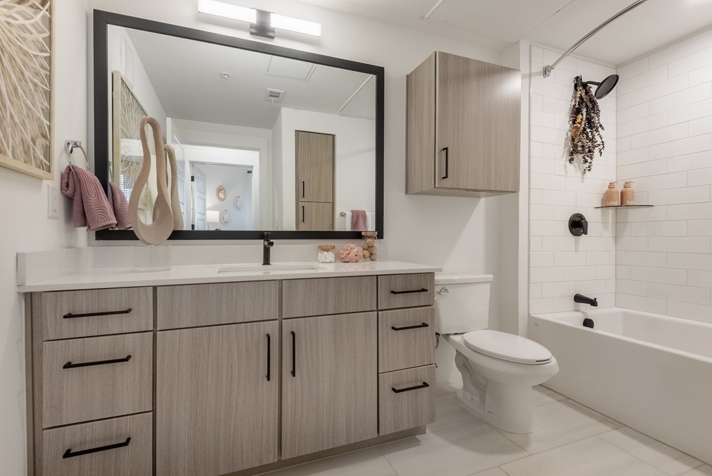A bathroom with a white tub and sink.