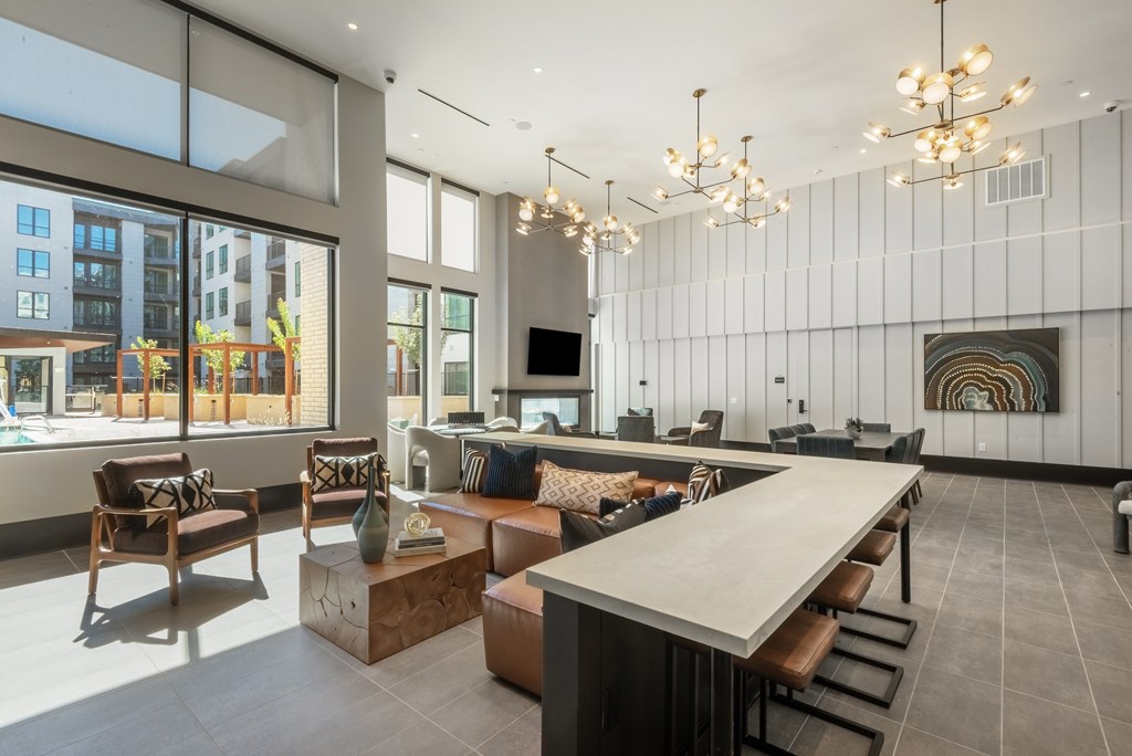 A modern living room with a long table and chairs.