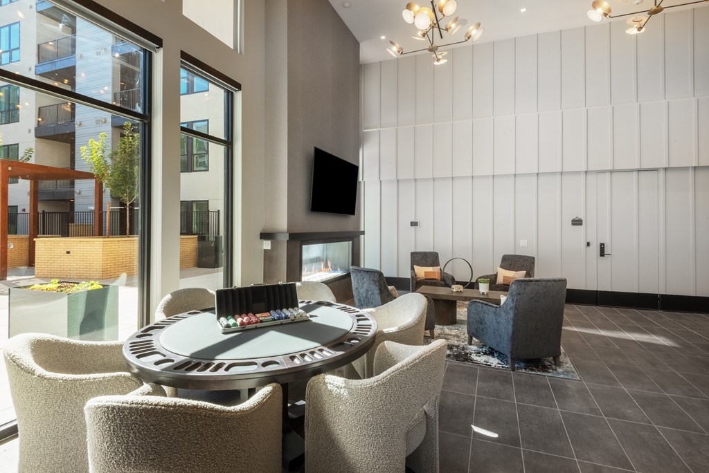 A modern lounge area with a round table and chairs.