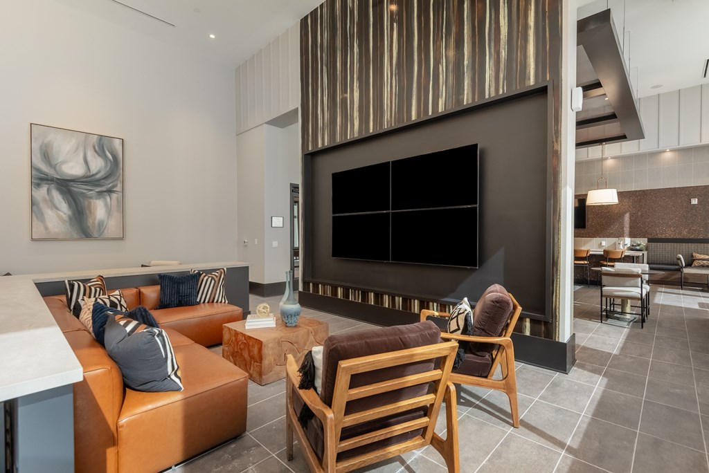 A modern living room with a fireplace and a painting on the wall.