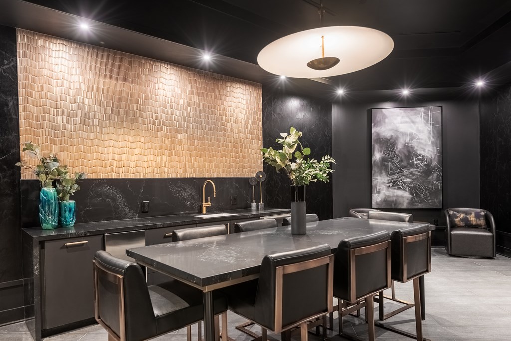 A modern kitchen with a dark theme and a large island.