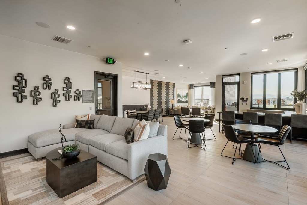 A modern living room with a white sofa, a coffee table, and a fireplace.