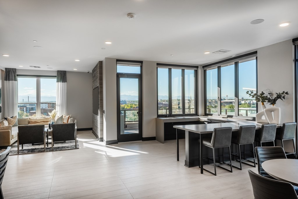 A modern living room with a dining table and chairs.