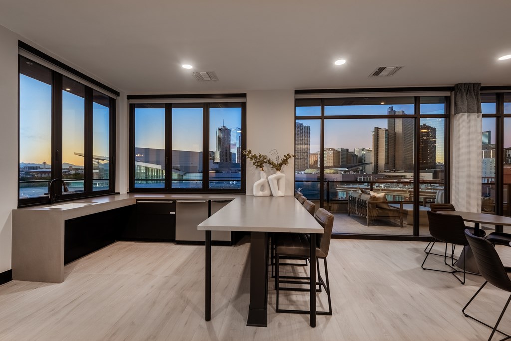 A modern dining room with a view of the city skyline.