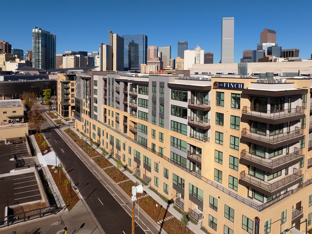 A view of a city with apartment buildings and a road.