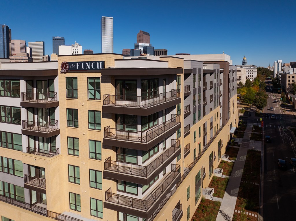 The Finch building is a large, multi-story apartment complex with balconies and a mix of beige and brown exterior colors.