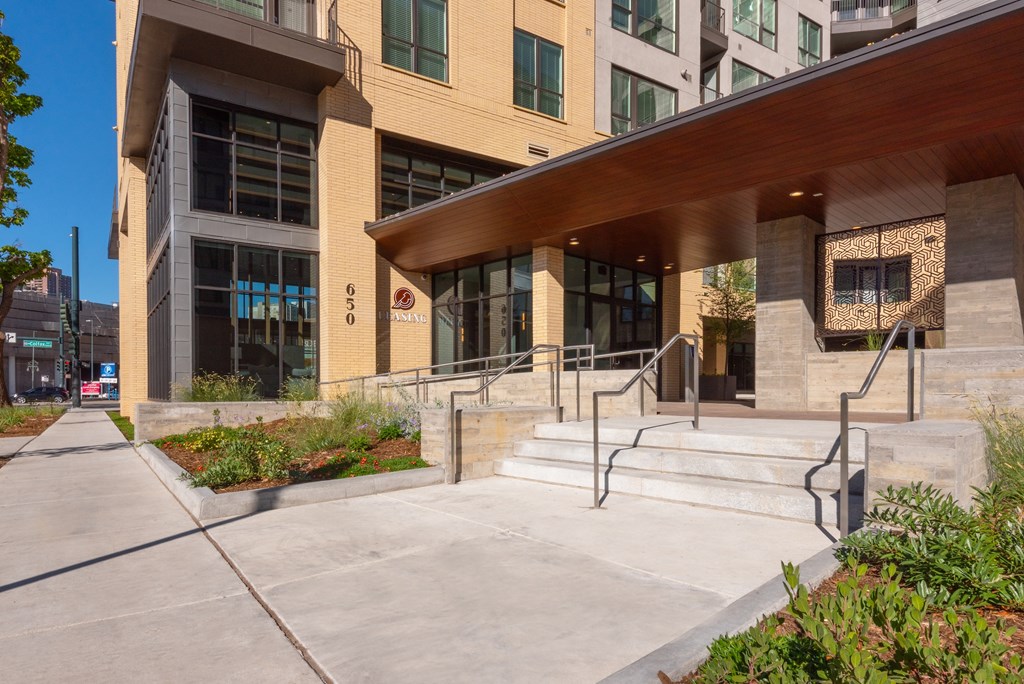 A modern building with a beige facade and a wooden overhang.