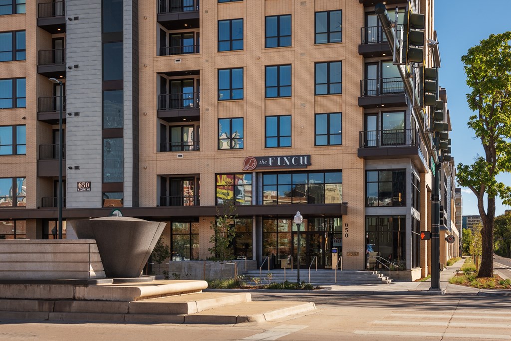 A modern building with a fountain in front of it.