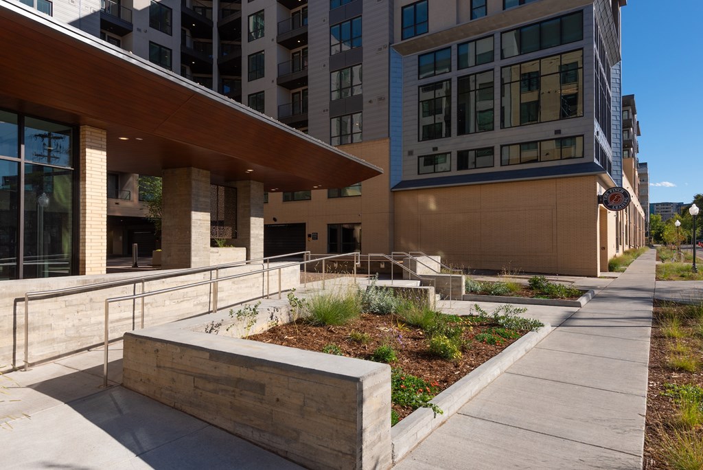 A modern building with a concrete walkway in front.