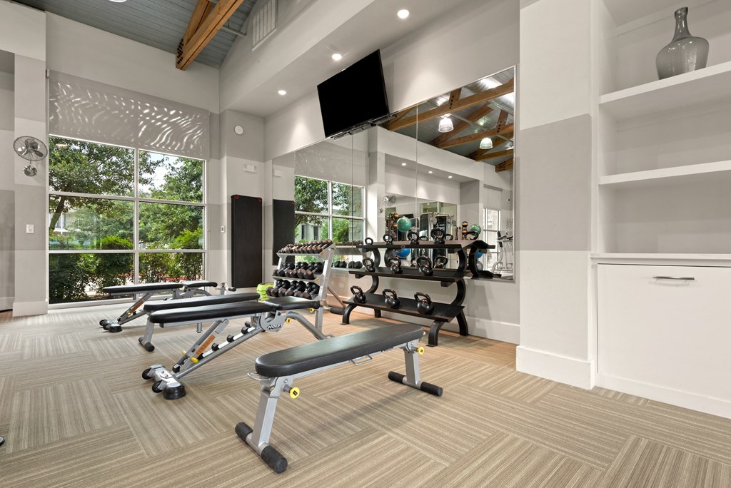 a spacious fitness center with treadmills and other exercise equipment