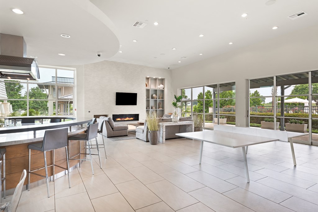 a living room filled with furniture and a large window