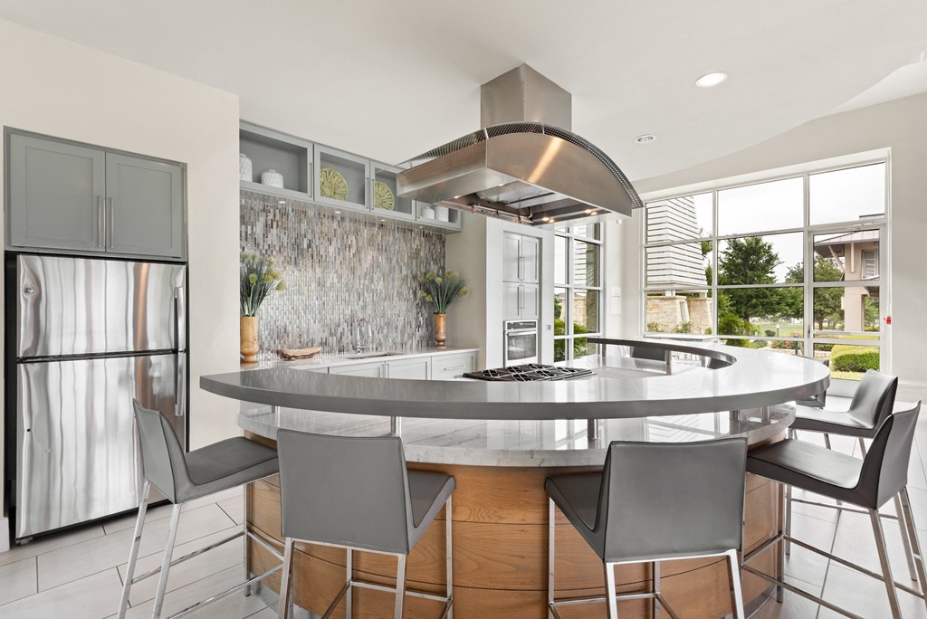 a kitchen with a large island with a breakfast bar