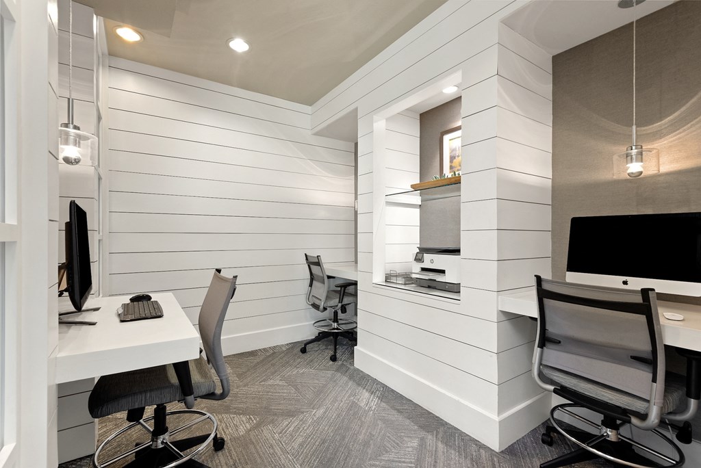 a workspace with two desks and two chairs