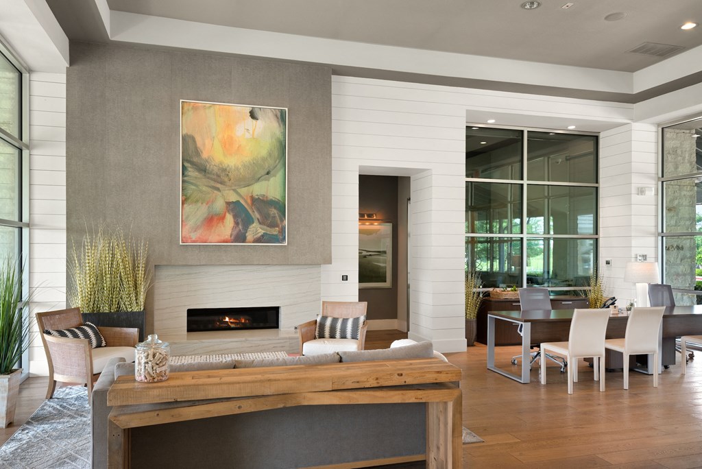 a living room with a fireplace and a dining room in the background