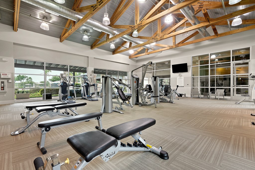 a spacious fitness center with treadmills and other exercise equipment