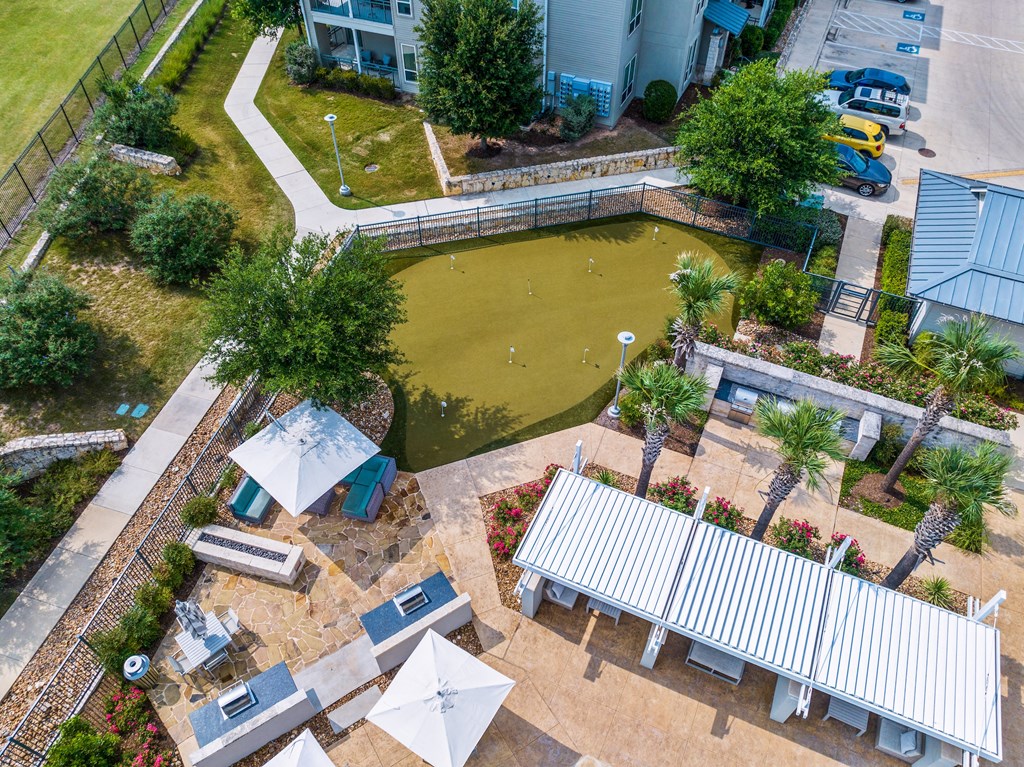 an aerial view of the koi pond and patio at the whispering winds apartments in pearland