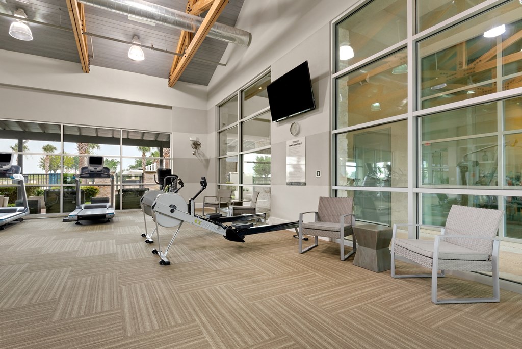 a resident fitness center with a treadmill and elliptical machine
