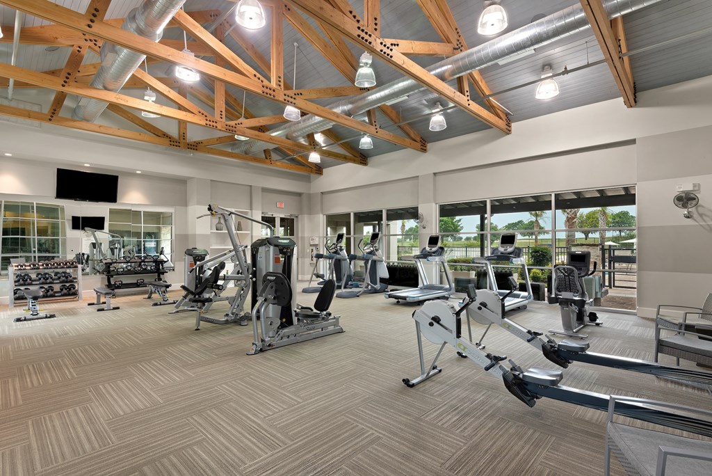a spacious fitness center with treadmills and other exercise equipment