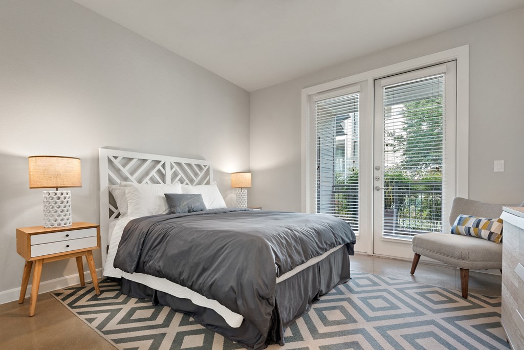 a bedroom with a bed and a chair