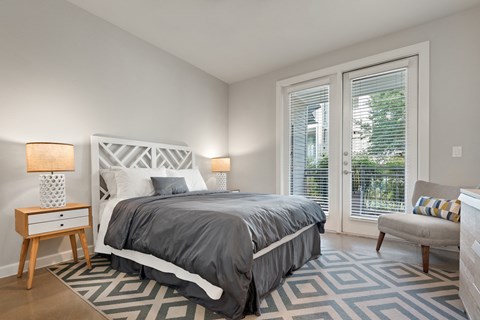 a bedroom with a bed and a chair