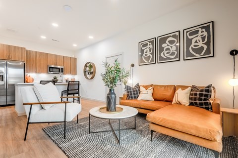 A living room with a white sofa and a coffee table.