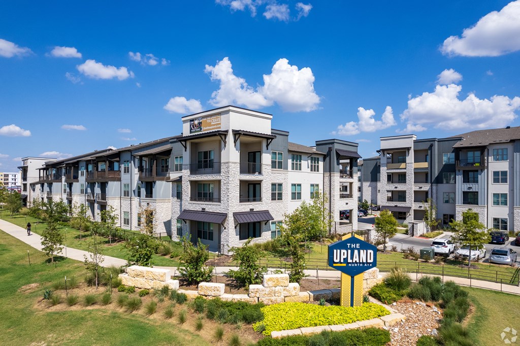 a large apartment building with a sign in front of it