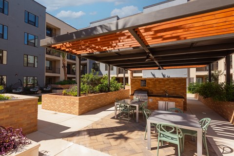 a patio with a table and chairs under awning
