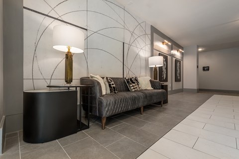 a living room with a couch and two lamps