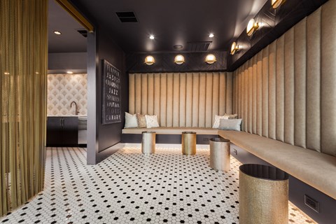 a seating area with a bench and a sink in the background