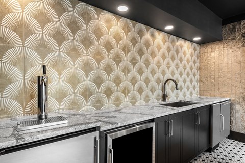 a kitchen with a large counter with a sink and a faucet