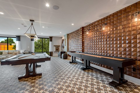 a game room with a pool table and a foosball table