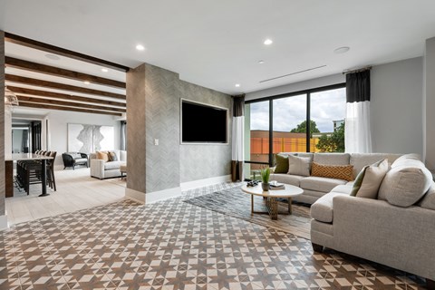 a living room filled with furniture and a large window
