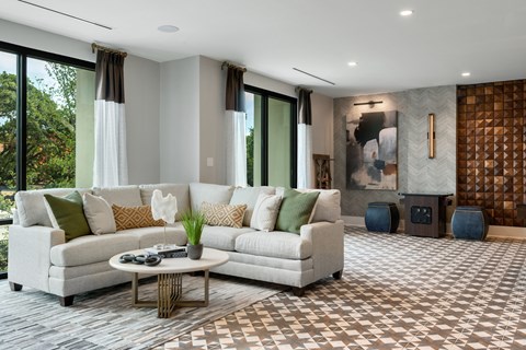 a living room filled with furniture and a large window