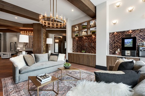 a living room filled with furniture and a large chandelier