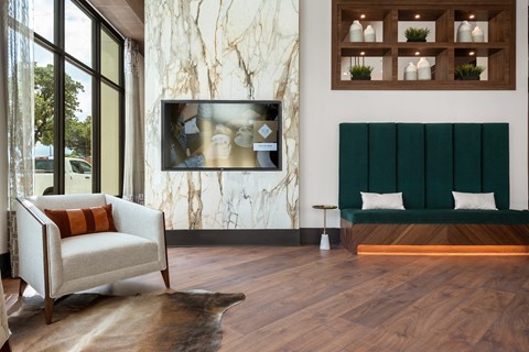 a living room with a sofa and a tv on the wall