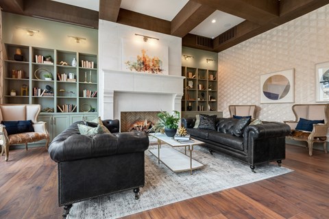 a living room with two leather couches and a fireplace