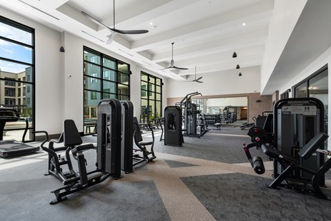 a gym with exercise equipment and windows