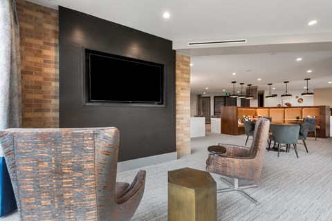 a living room filled with furniture and a flat screen tv