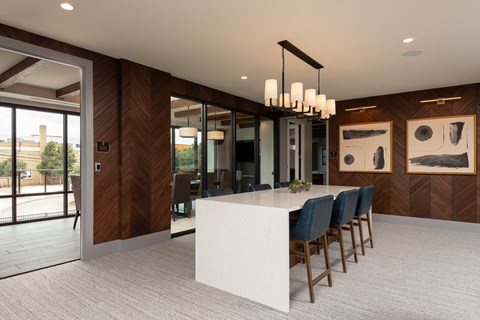 a rendering of a large room with a long white table and blue chairs