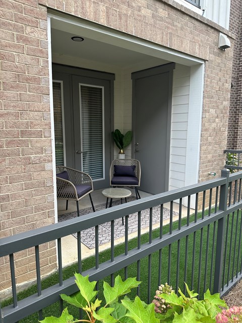 A patio with a table and chairs is visible through a doorway.