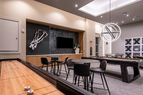 a room with a pool table and a flat screen tv  at Encore at Boulevard One, Denver, 80230