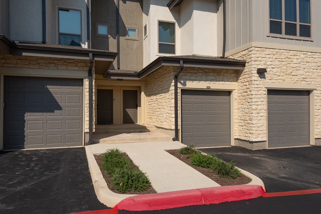 a street view of a building with three garage doors