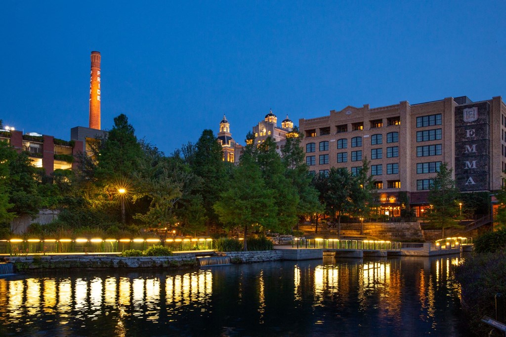 a city at night with a river and buildings