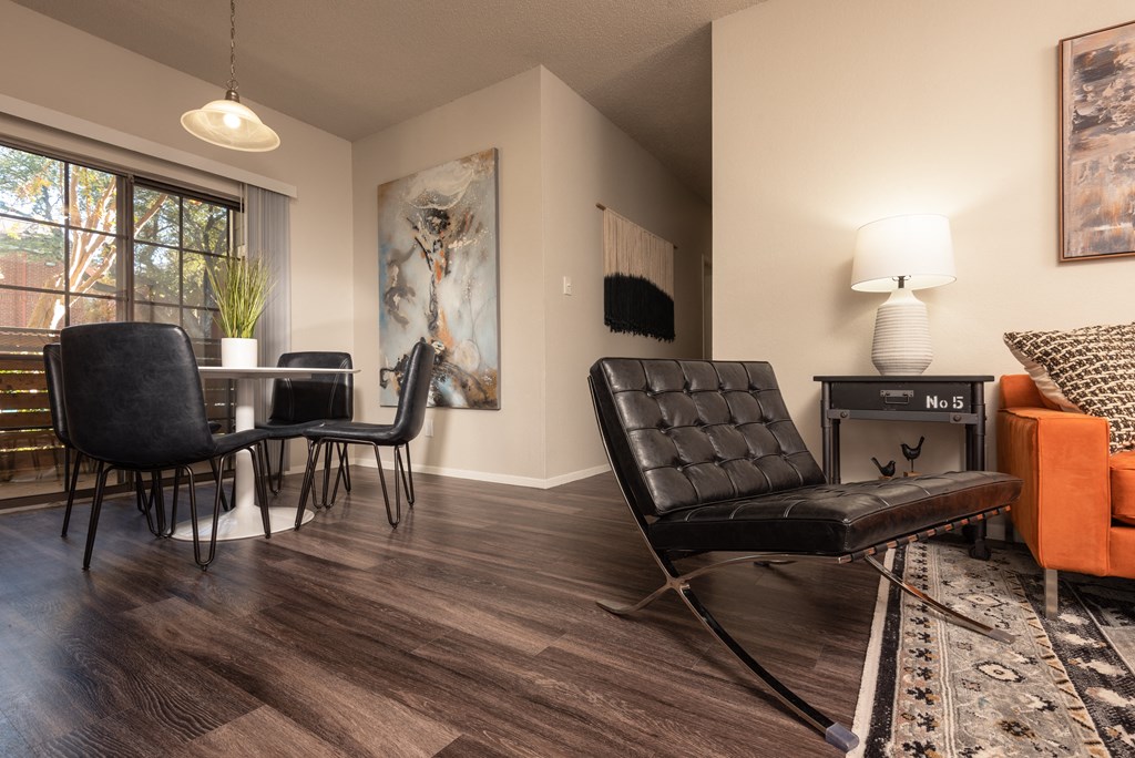 an open living room and dining room with a table and chairs