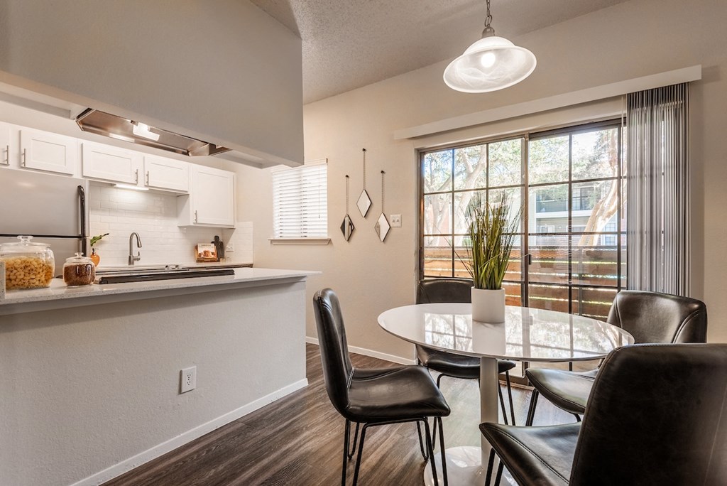 an open kitchen and dining area with a table and chairs