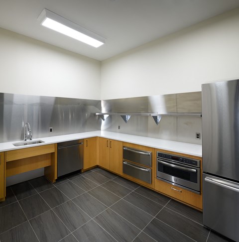 a kitchen with stainless steel appliances and wooden cabinets